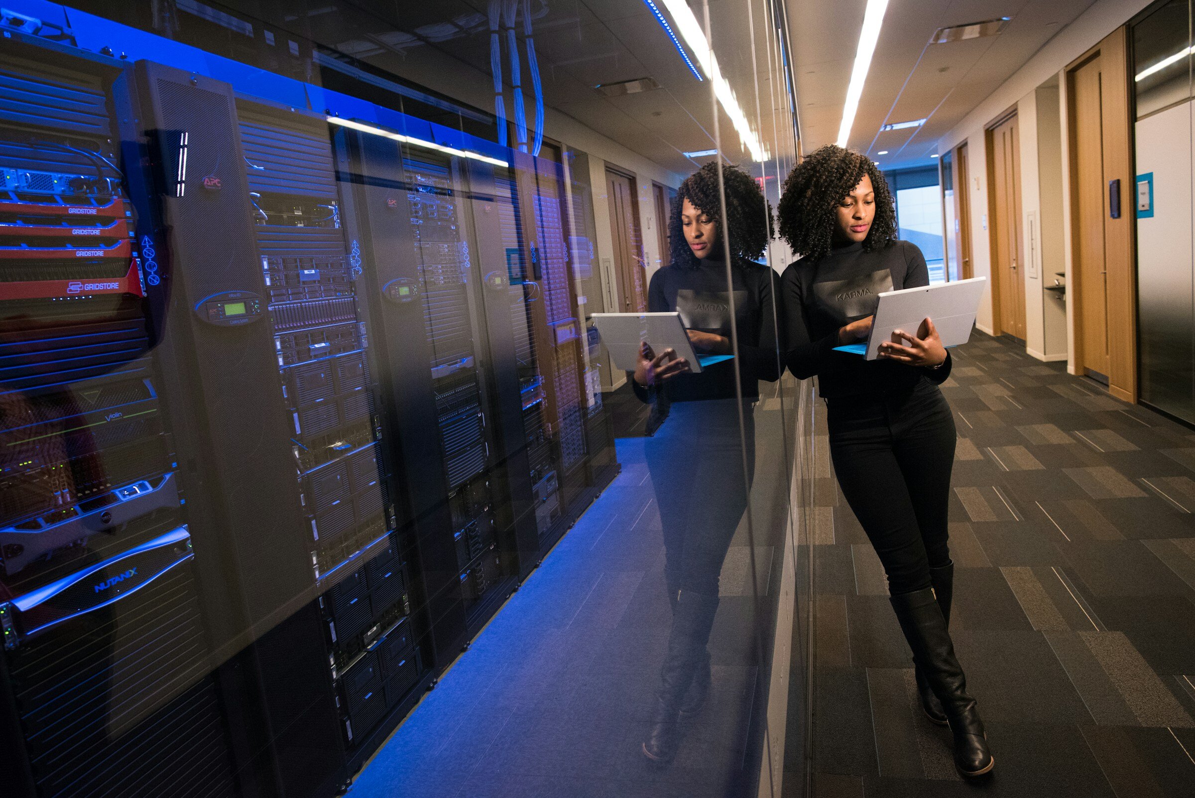 Woman Standing in Server Room - Kubernetes Application Monitoring