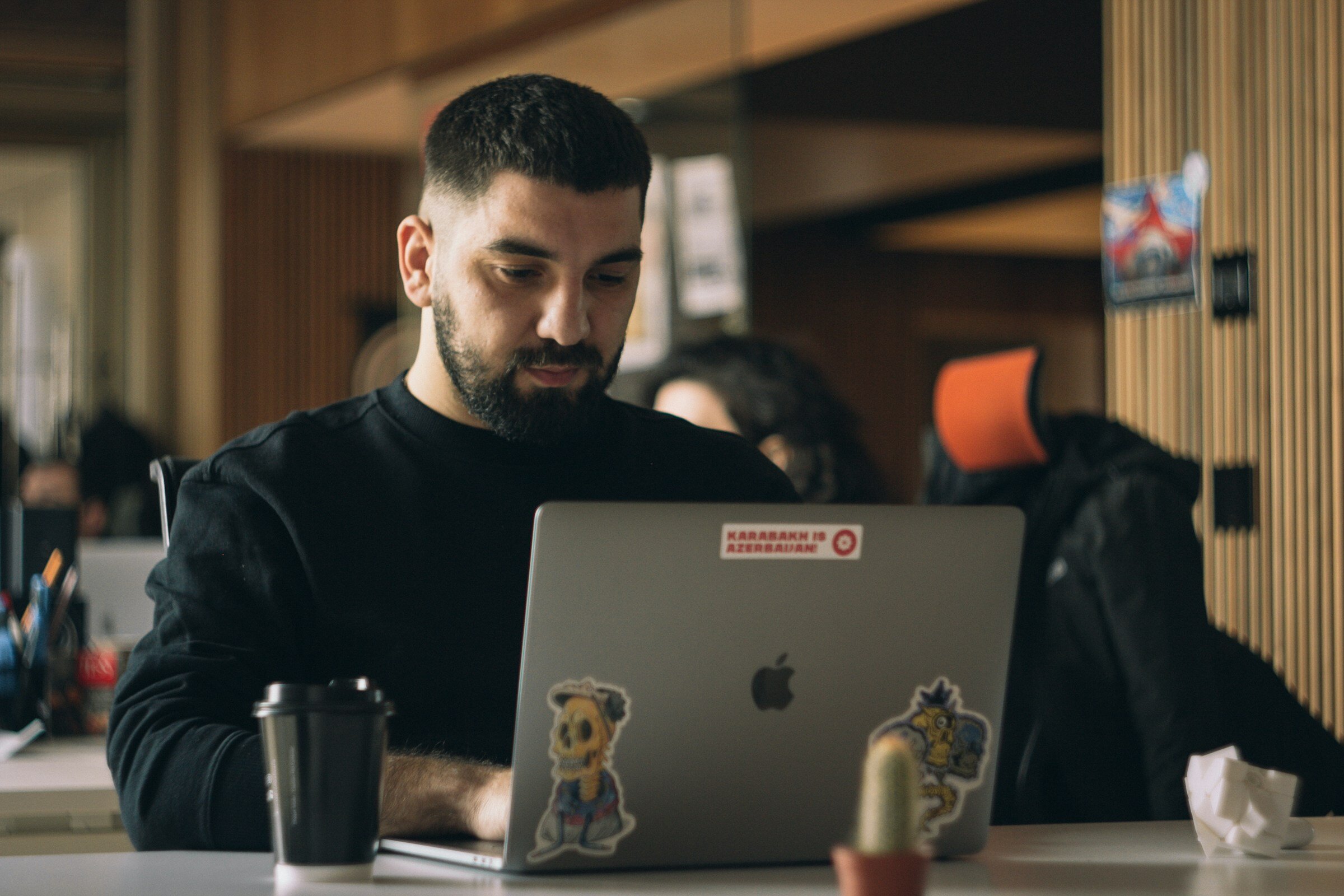 man looking at laptop - Log Monitoring Tools