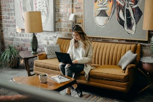 person sitting on couch and working - Node Js Performance Testing