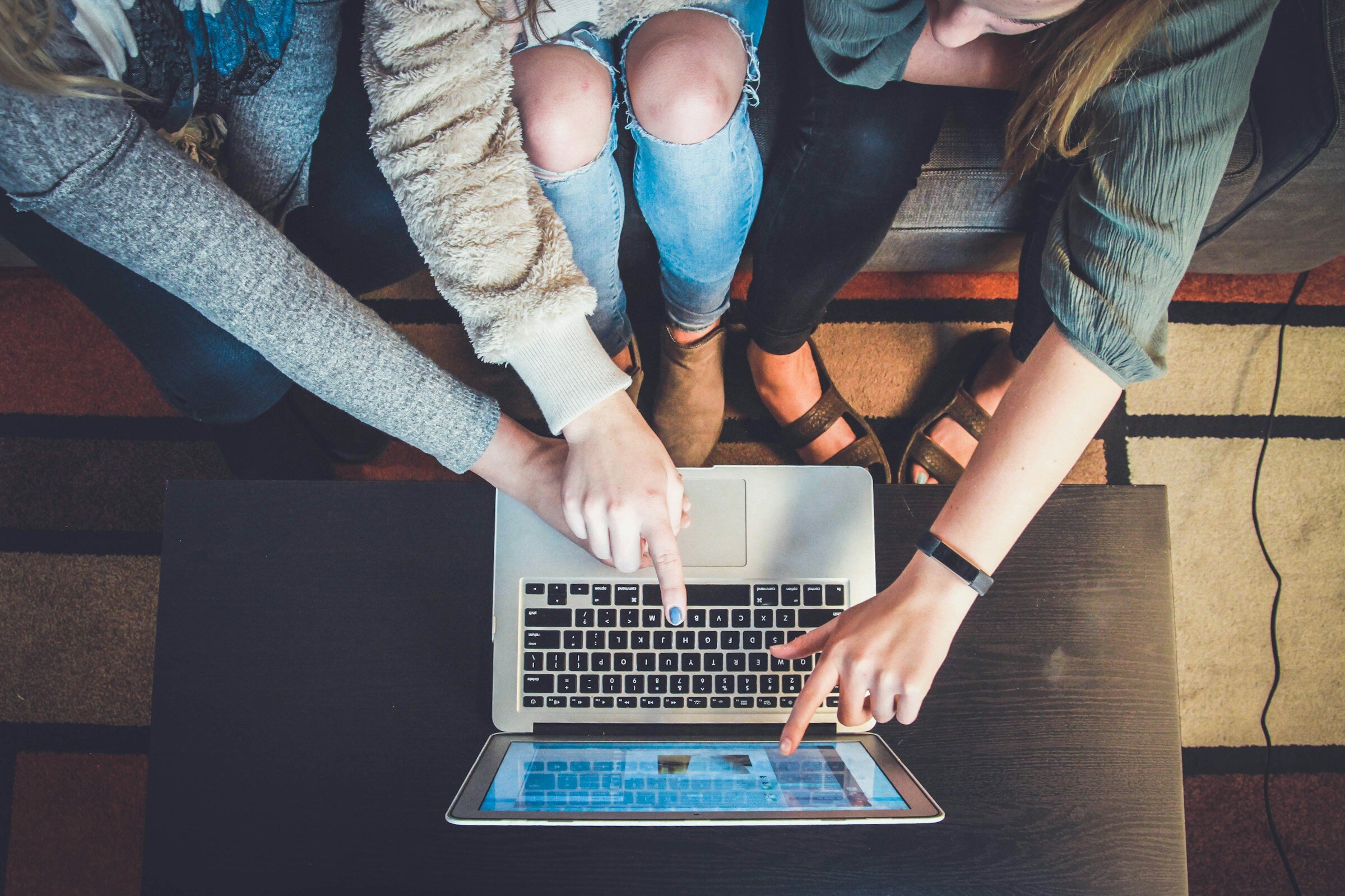 Persons Pointing at Laptop - Opentelemetry Alternatives