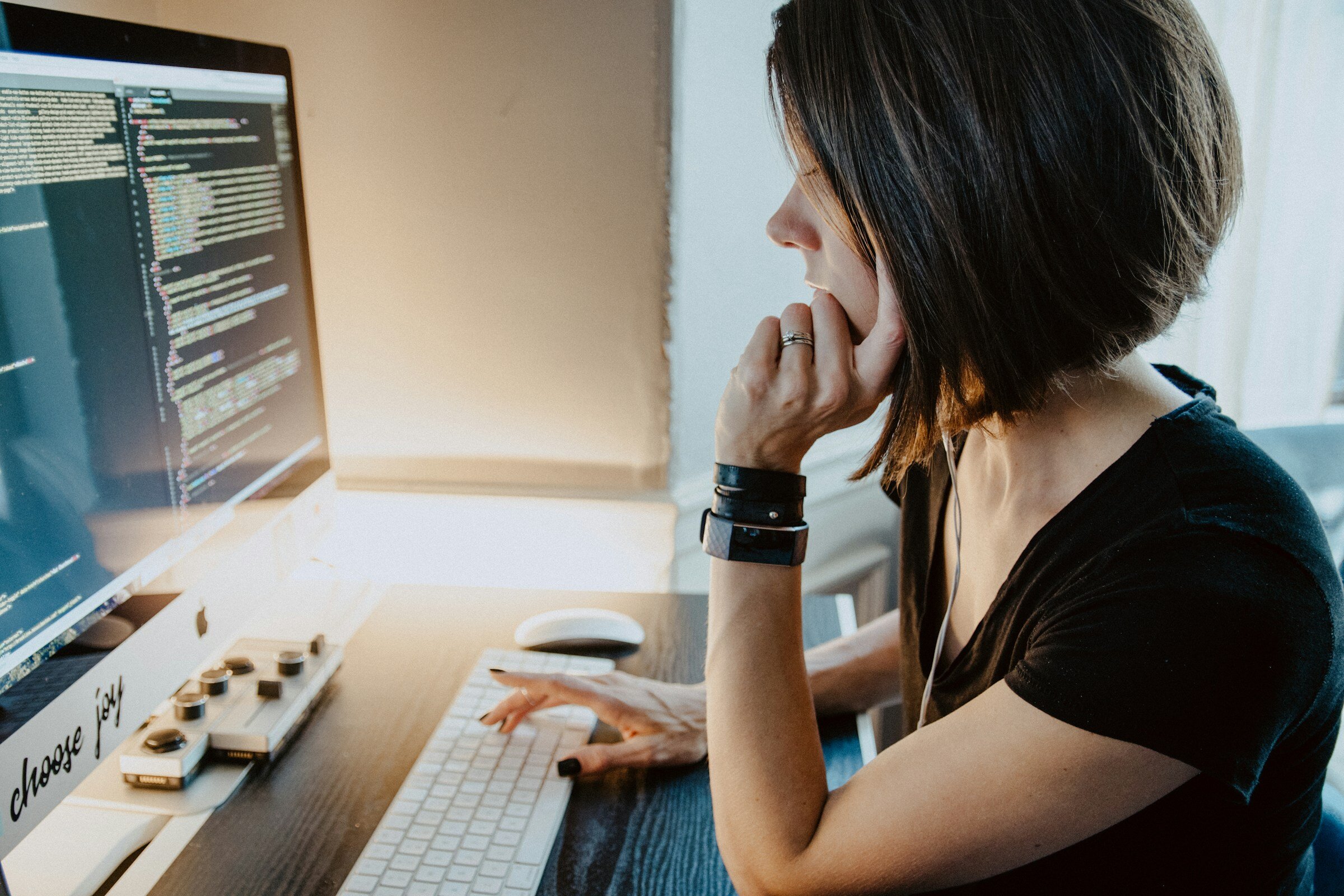 Girl Coding on Computer - Front End Monitoring Tools