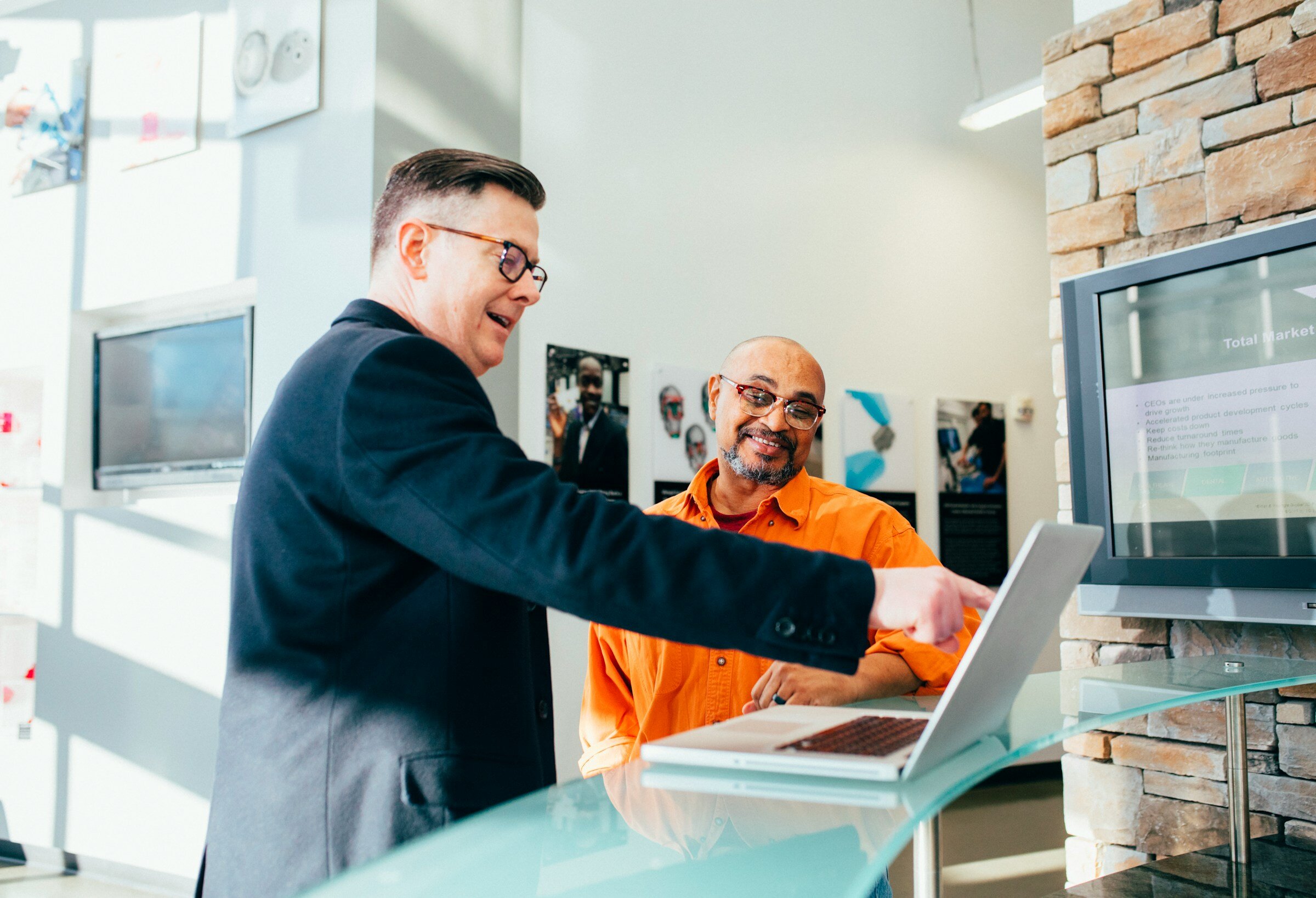 Person Pointing at Laptop - Automated Application Monitoring Tools