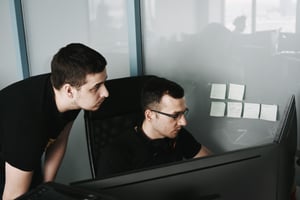 Two People Looking at Computer - Automated Application Monitoring Tools