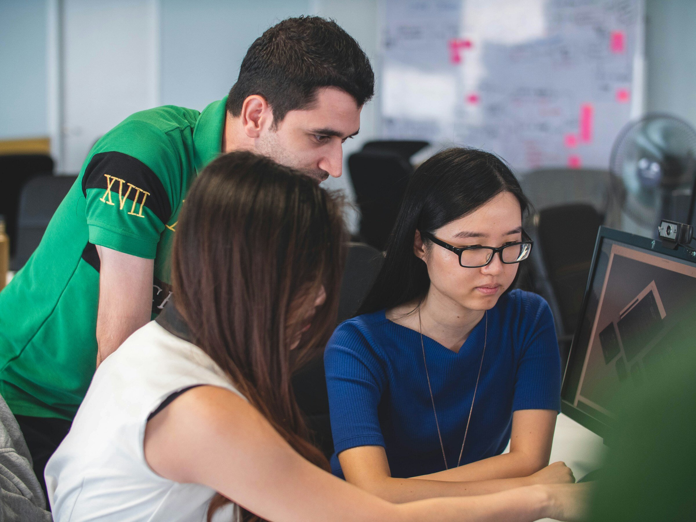 team infront of laptop - Node JS Performance Monitoring