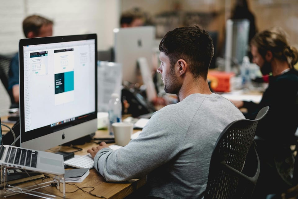 man infront of laptop - Web App Monitoring